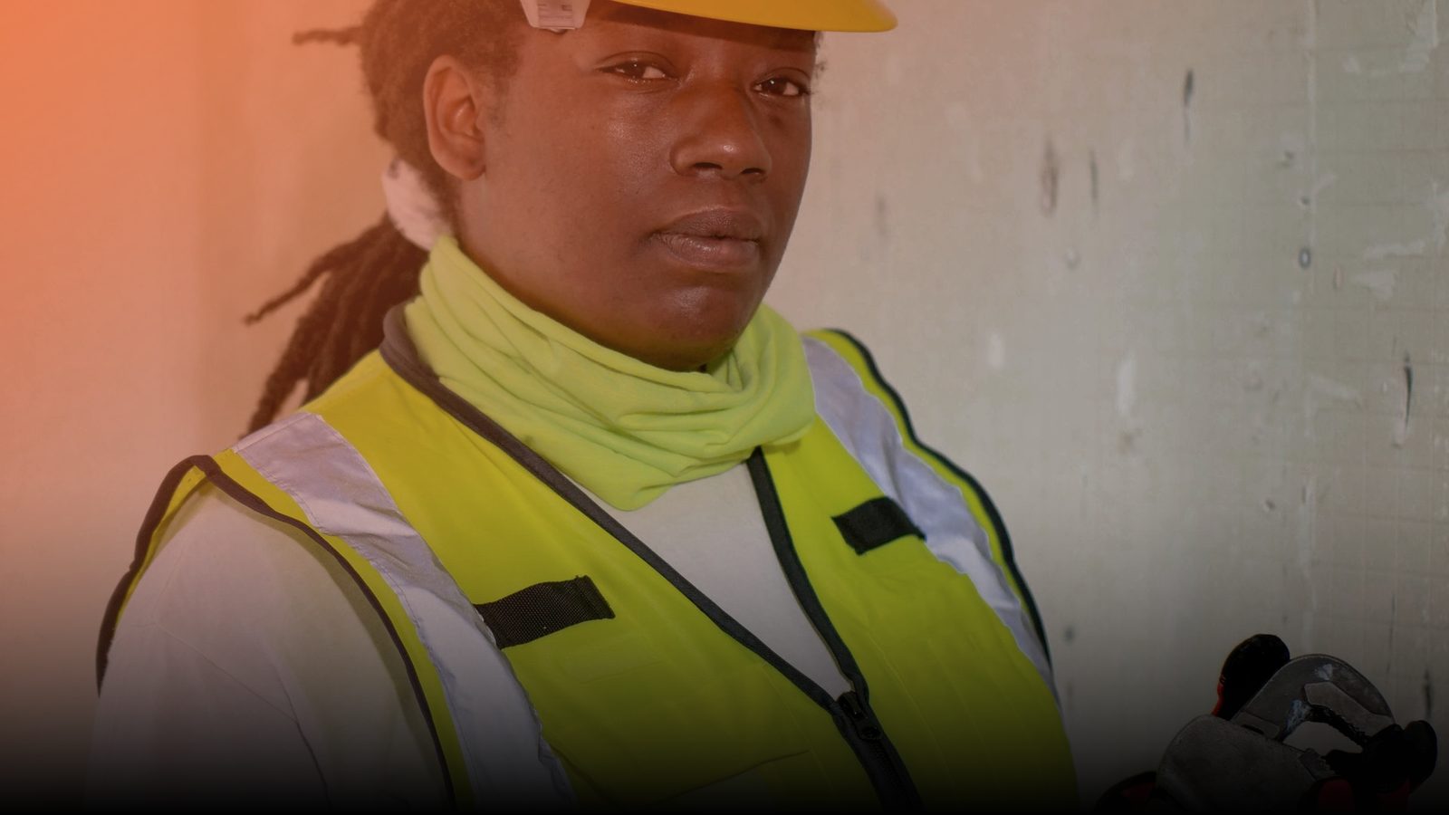 A home services technician in a hard hat on a job