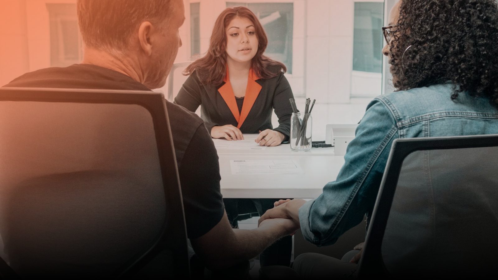 An insurance agent meeting clients in an office
