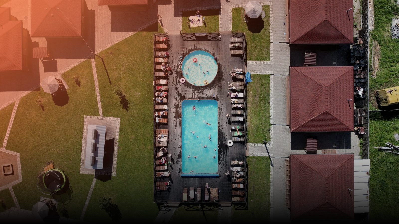 An overhead view of a backyard swimming pool and lounge chairs