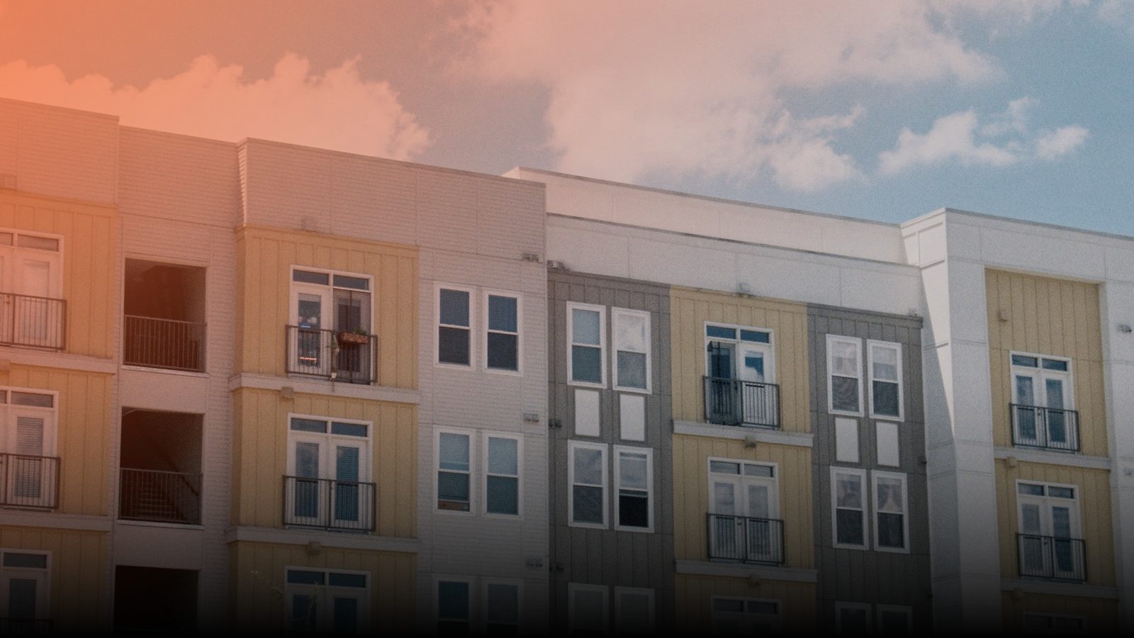 A modern apartment building against a blue sky