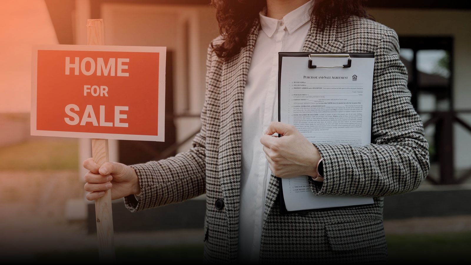 A real estate agent holding a Home For Sale sign and a clipboard