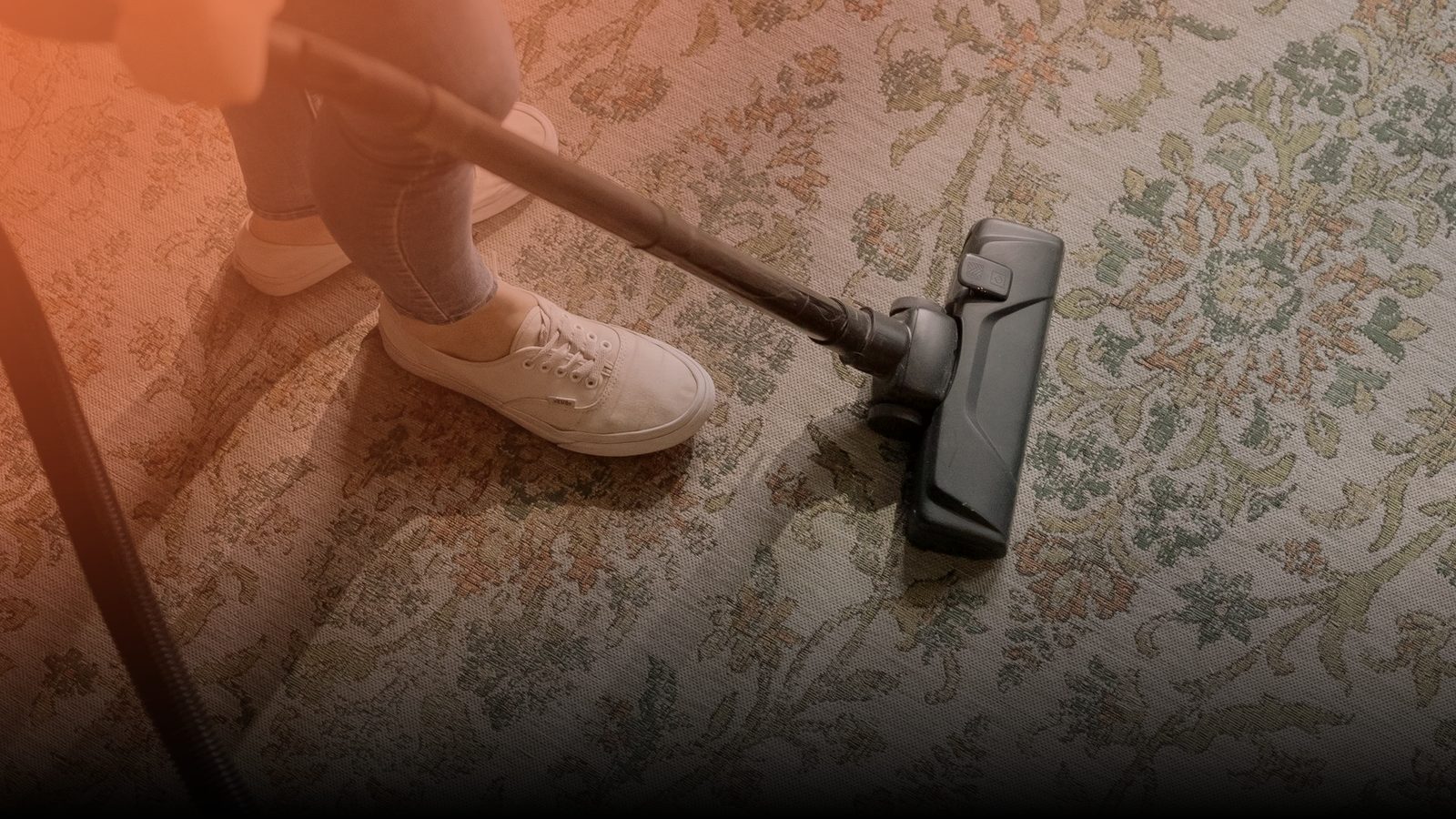 A restoration technician running a machine over a water-stained carpet