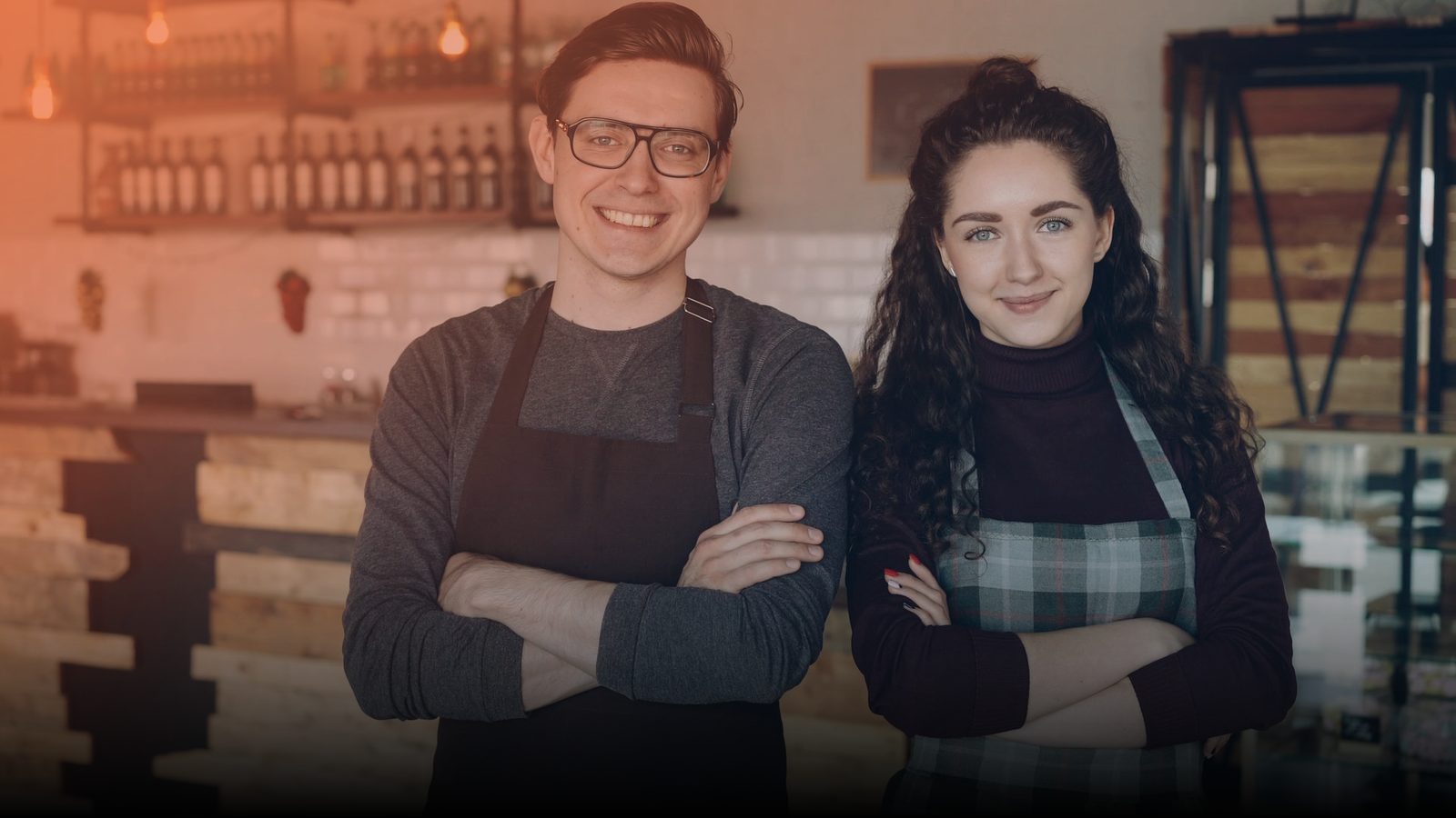 Two small business owners standing in their shop