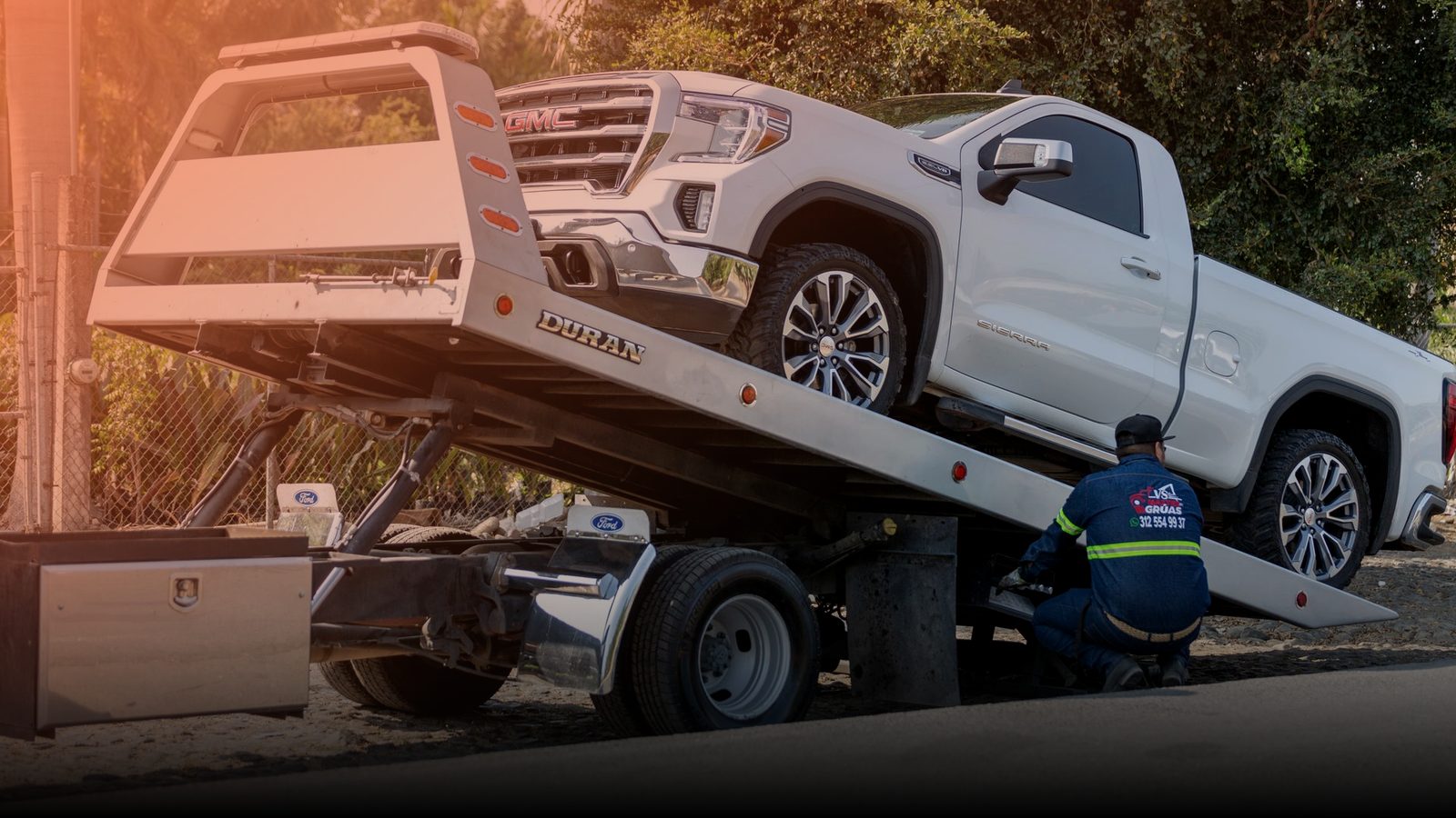 A pickup truck being loaded onto a flatbed tow truck